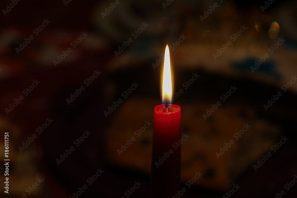 Burning candle on a dark background Burning candle on a dark background