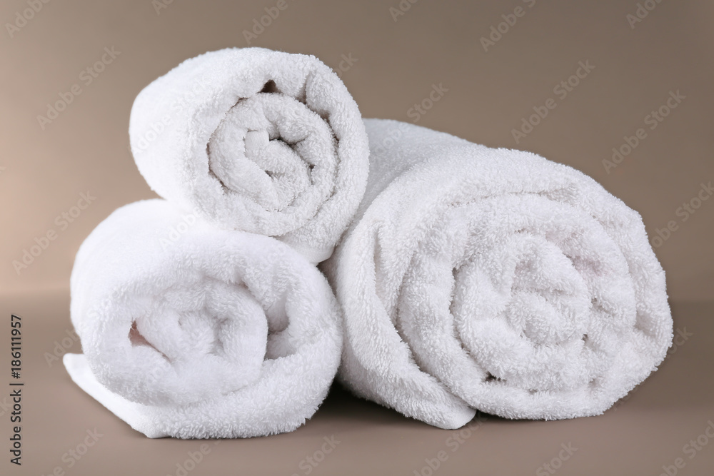 Rolled terry towels on color background Rolled terry towels on color background