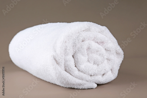 Rolled terry towel on color background