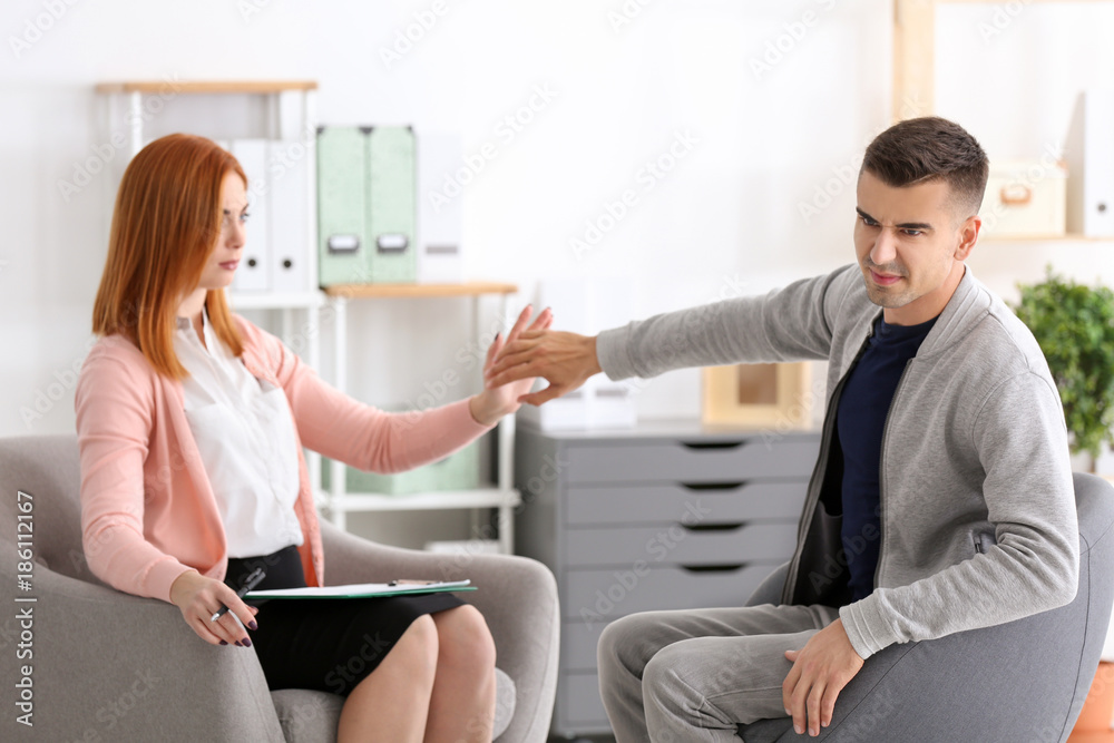 Fototapeta premium Female psychologist with client in office