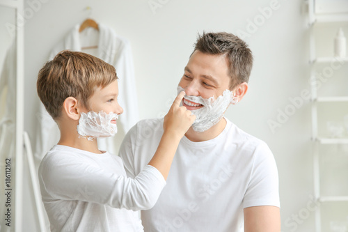 Father and son shaving toge...
