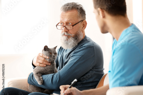 Caregiver with senior man a...