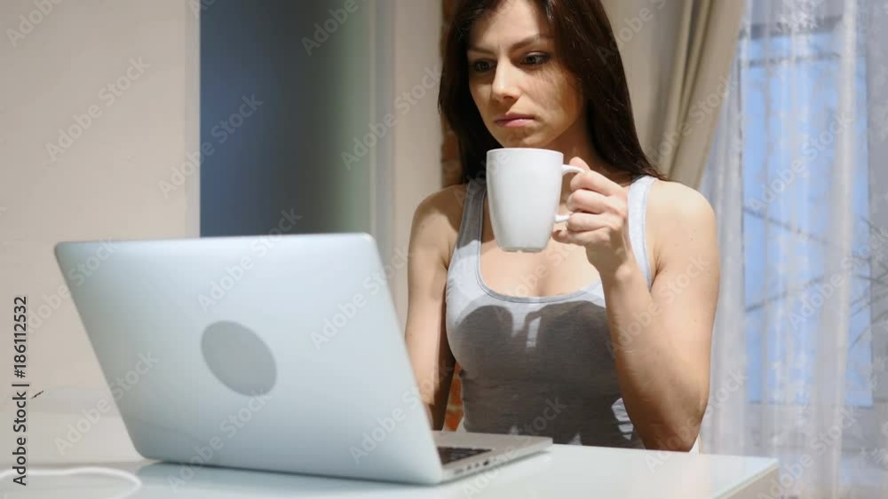 Portrait of Young Woman Drinking Coffee and Working on Laptop Portrait of Young Woman Drinking Coffee and Working on Laptop