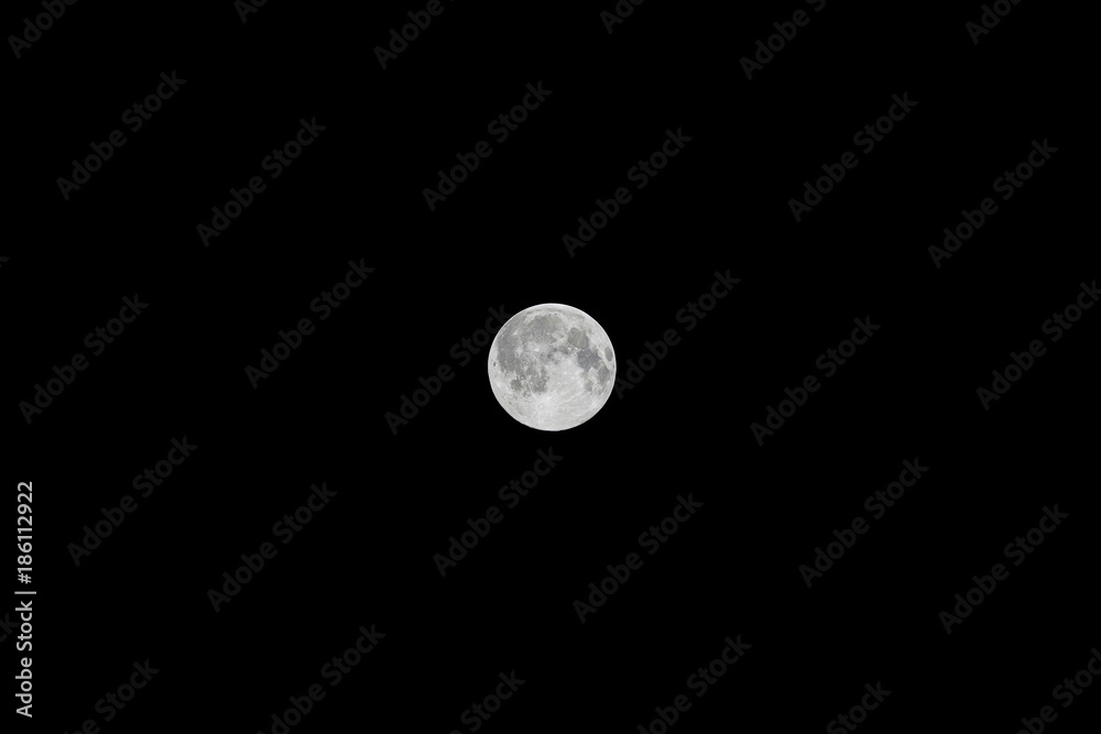 Small full moon on black night sky background Small full moon on black night sky background