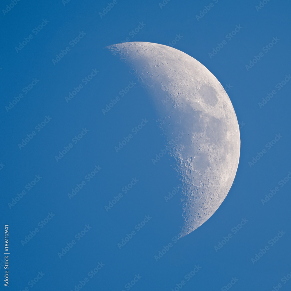 Moon - Waxing Crescent against blue sky background
