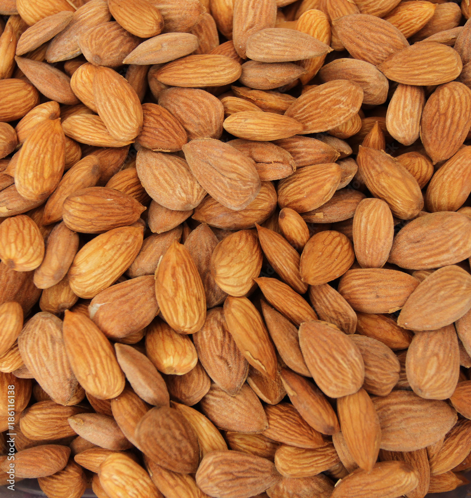 Fototapeta premium Almonds. Raw fresh organic almond nuts. Almond background. Nuts background. Almond texture and background
