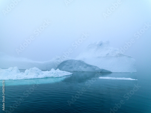 Icebergs in foggy day on Arctic Ocean in Greenland © murattellioglu