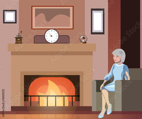 Grandmother sits in a chair near the fireplace