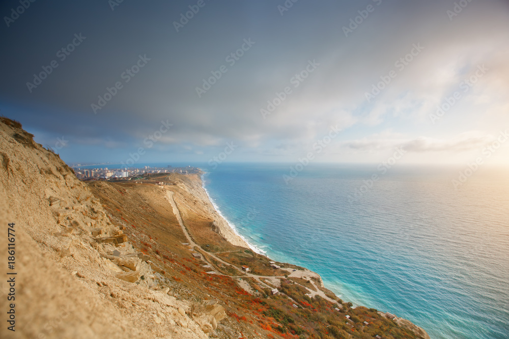 Mountains and a sea landscape with the blue sky. Black Sea, Russia. Beautiful view of the city.