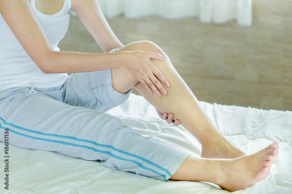 Fototapeta premium woman massaging her leg