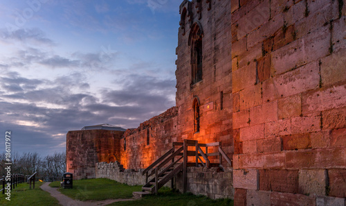 Beautiful sunset on ancient Stafford Castle with colorful sky and light on castle.