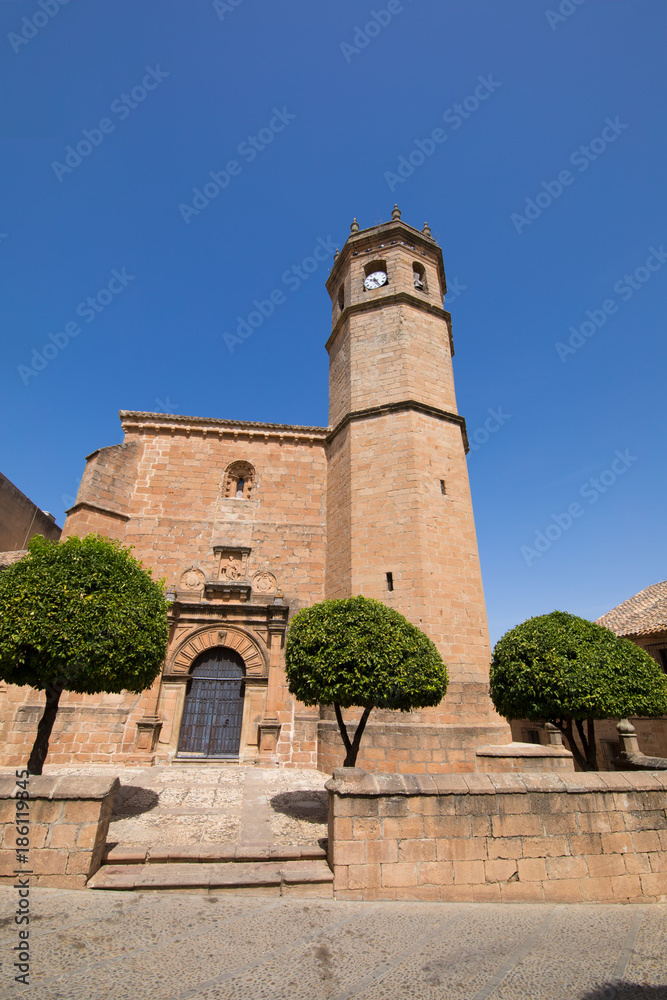 landmark of facade and bell tower of church San Mateo, gothic and renaissance from Fifteenth century, in old town of Banos de la Encina, Jaen, Andalusia, Spain Europe
