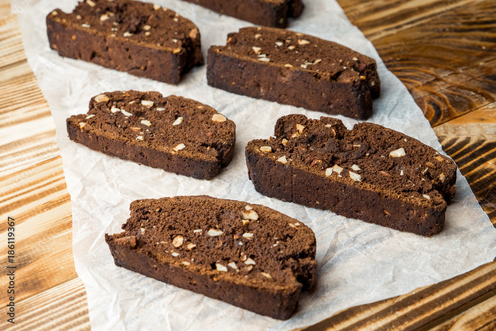 emade chocolate biscotti cookies with almonds on parchment paper emade chocolate biscotti cookies with almonds on parchment paper