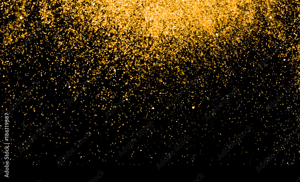 waterfalls of golden glitter sparkle bubbles champagne particles stars on black background,happy new year holiday concept