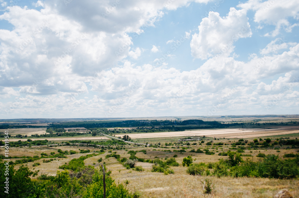 Landscape with summer steppe and cloudy sky in Donbass region of Ukraine