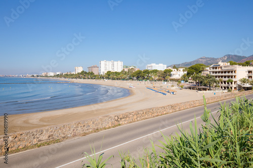 landscape sandy Voramar Beach  in Benicassim  Castellon  Valencia  Spain  Europe. Buildings  blue clear sky and Mediterranean Sea. Horizontal  