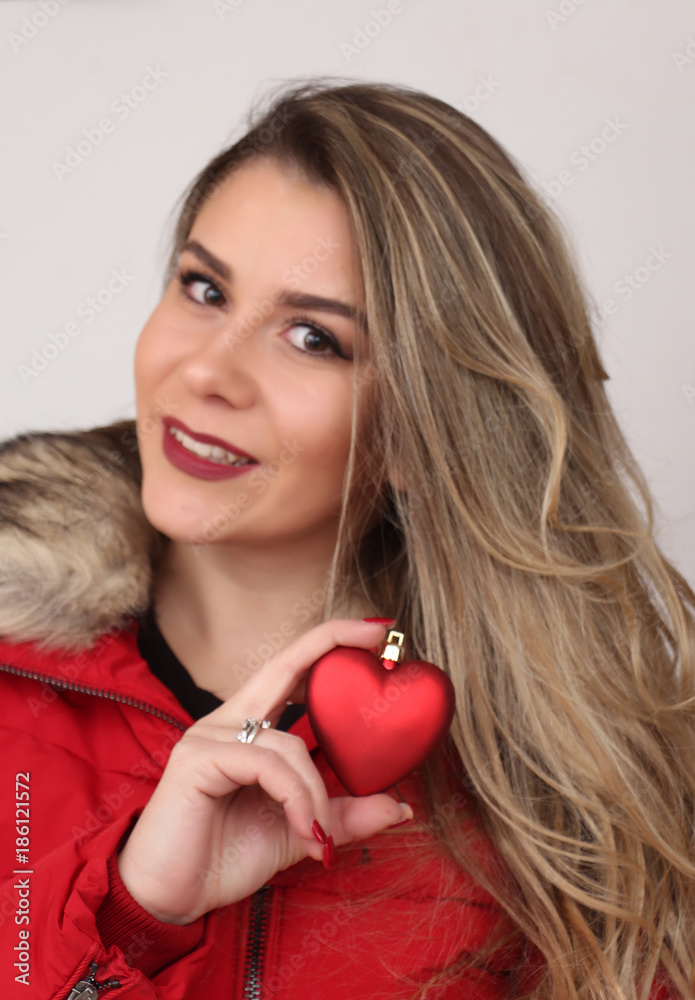 studio portrait of a beautiful model girl, smiling and holding heart studio portrait of a beautiful model girl, smiling and holding heart