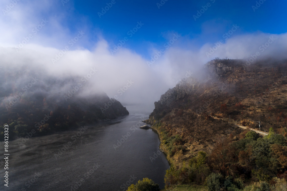 Aerial view of the Portas de Rodao covered in mist in the Tagus River, Portugal; Concept for travel in Portugal