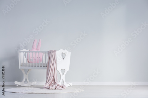 White baby's bedroom with cradle photo