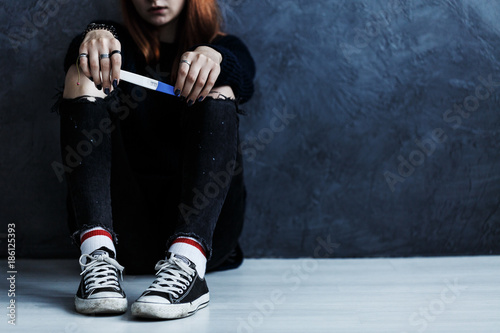Teenager with pregnancy test photo