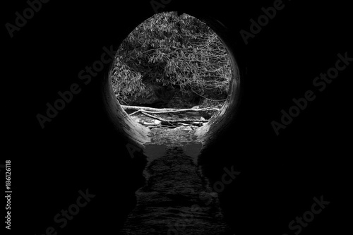 Black and White Artisctic Photograph of a River Drain Pipe. photo