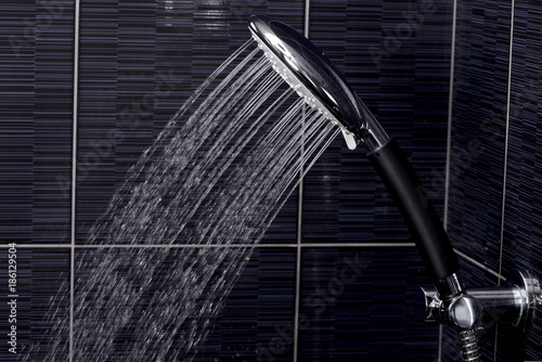 Fototapeta Naklejka Na Ścianę i Meble -  chrome shower head with flowing water