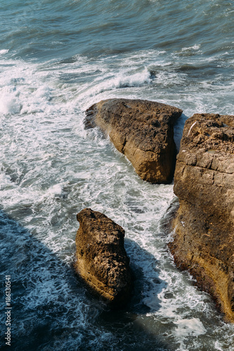 Waves crash on the rocks photo