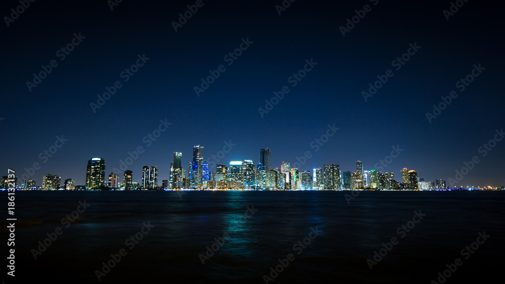 USA, Florida, Miami City Skyline at night with waterfront and reflections