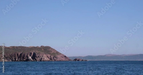 Video shot of Tuerredda beach on a beautiful day with sea and boat in view photo