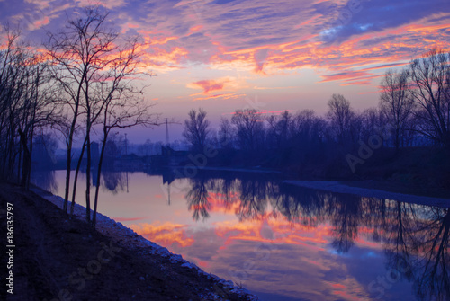 Brescia Italy, beautiful colors of the sunset on the river. © Luca
