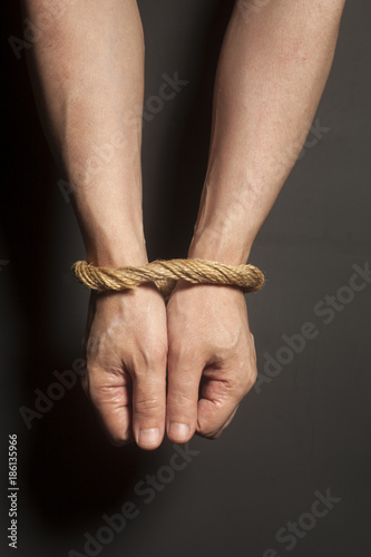 Fotografie Male hands bound with rope
