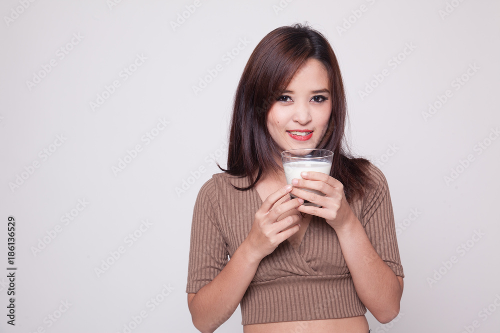 Healthy Asian woman drinking a glass of milk. Healthy Asian woman drinking a glass of milk.
