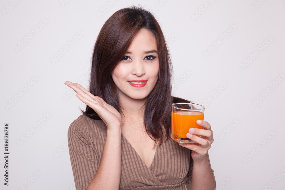 Happy Young Asian woman drink orange juice. Happy Young Asian woman drink orange juice.