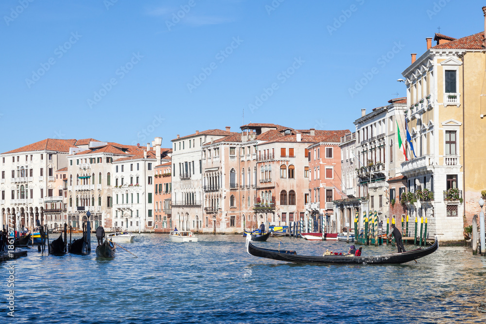 Gondola with tourists on the Grand Canal in Cannaregio, Venice, Italy rowing towards Rialto Mercato 