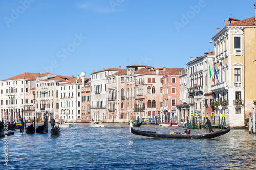 Gondola with tourists on the Grand Canal in Cannaregio, Venice, Italy rowing towards Rialto Mercato 