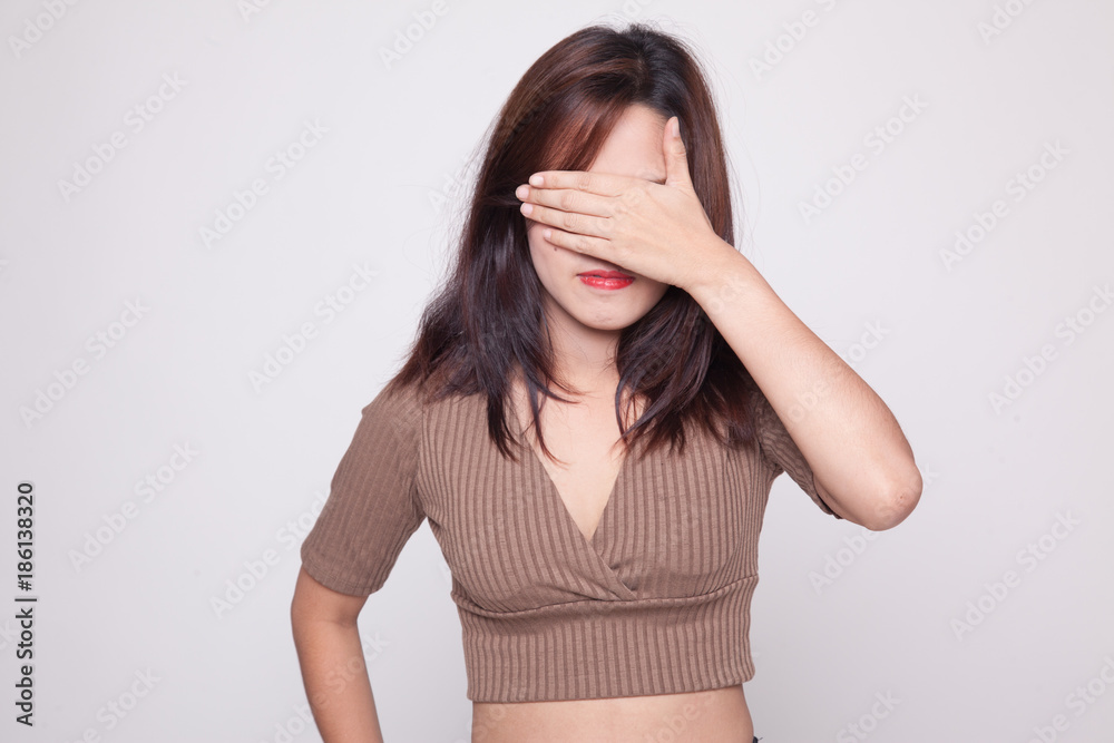 Young Asian woman close her eyes with hand. Young Asian woman close her eyes with hand.
