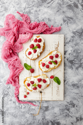 Breakfast slice of bread with Ricotta cheese served with raspberries