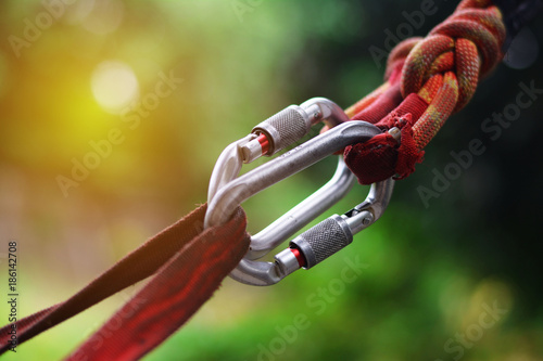 Climbing sports image of a carabiner on a rope. Close-up of carbine photo