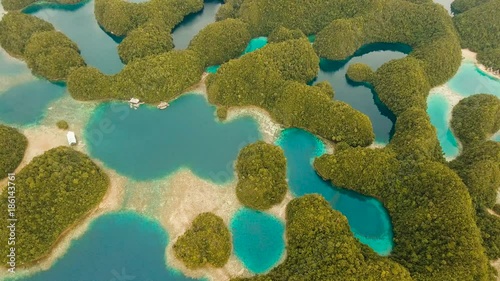 Aerial view: Bucas Grande Island, Sohoton Cove. Philippines. Tropical sea bay and lagoon, beach. Tropical landscape hill, clouds and mountains rocks with rainforest. Azure water of lagoon. Shore photo