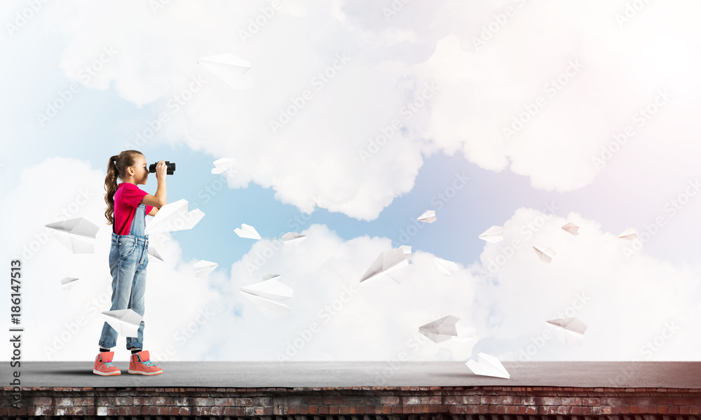 Concept of careless happy childhood with girl of school age looking in future Concept of careless happy childhood with girl of school age looking in future