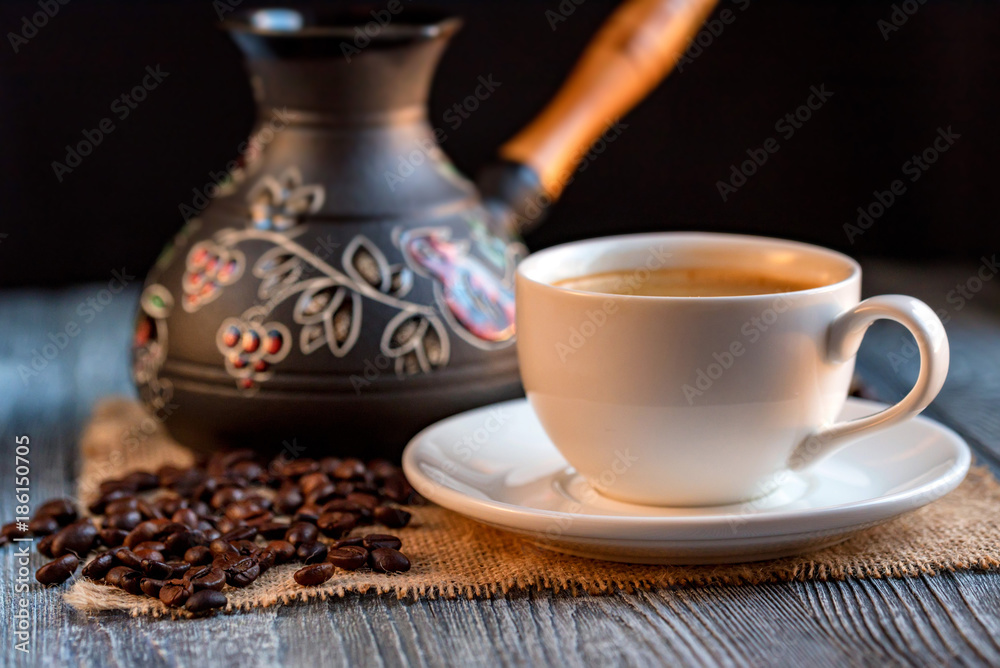 Cozy winter setting with cup of coffee and cezva Cozy winter setting with cup of coffee and cezva