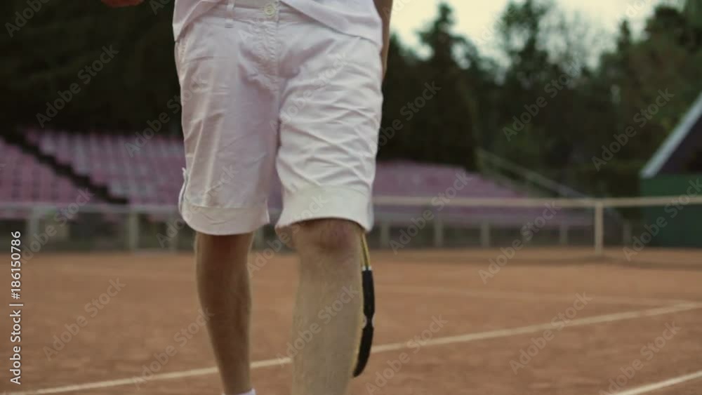 Man and woman in white sportswear walking on court, preparing to play tennis Man and woman in white sportswear walking on court, preparing to play tennis