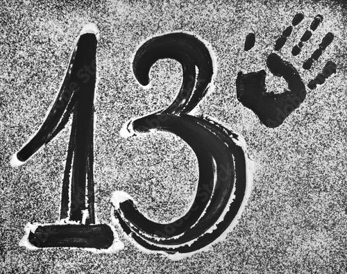 Figure 13 a palm print on a black background , sprinkled with white powder.