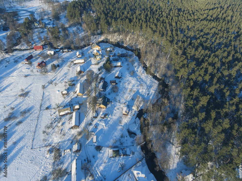 Aerial view over rural Latazeris village in Lithuania, Europe. During snowy cold winter day.