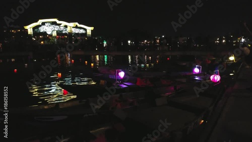 Hoi An night, UHD handheld pan view of a colorful lanterns, infront of Hoi An city, on a autumn night, in Vietnam