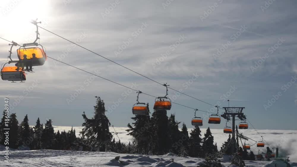 Ressort in the winter over the clouds with ski lift Ressort in the winter over the clouds with ski lift