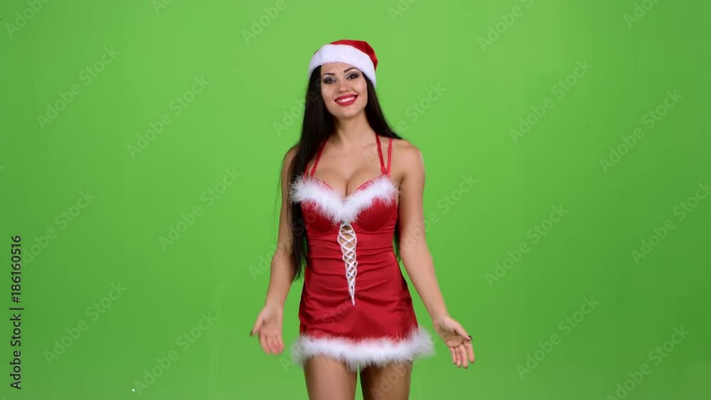 Santa girl walking by foot and sends and air kiss. Green screen Santa girl walking by foot and sends and air kiss. Green screen