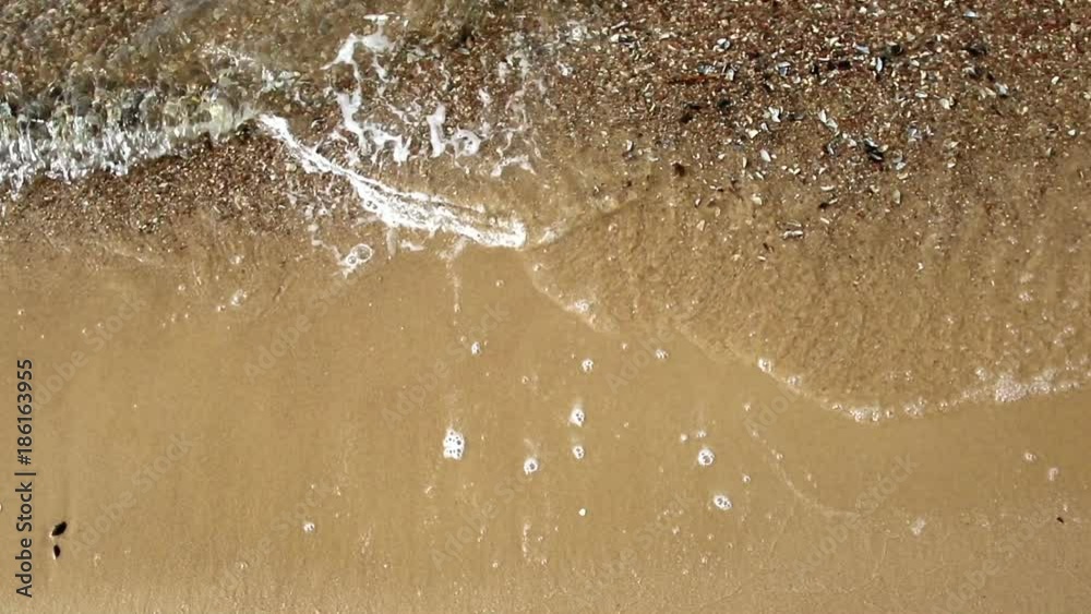 Sandy beach and waves on the shore.
Sandy beach and waves on the shore.