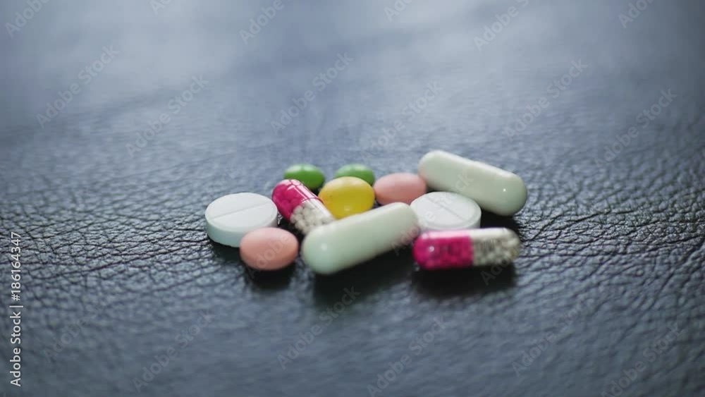 Pharmacy background on a black table. Tablets on a black background. Pills. Medicine and healthy. Close up of capsules. Pharmacy background on a black table. Tablets on a black background. Pills. Medicine and healthy. Close up of capsules.