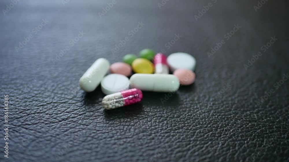 Pharmacy background on a black table. Tablets on a black background. Pills. Medicine and healthy. Close up of capsules. Pharmacy background on a black table. Tablets on a black background. Pills. Medicine and healthy. Close up of capsules.